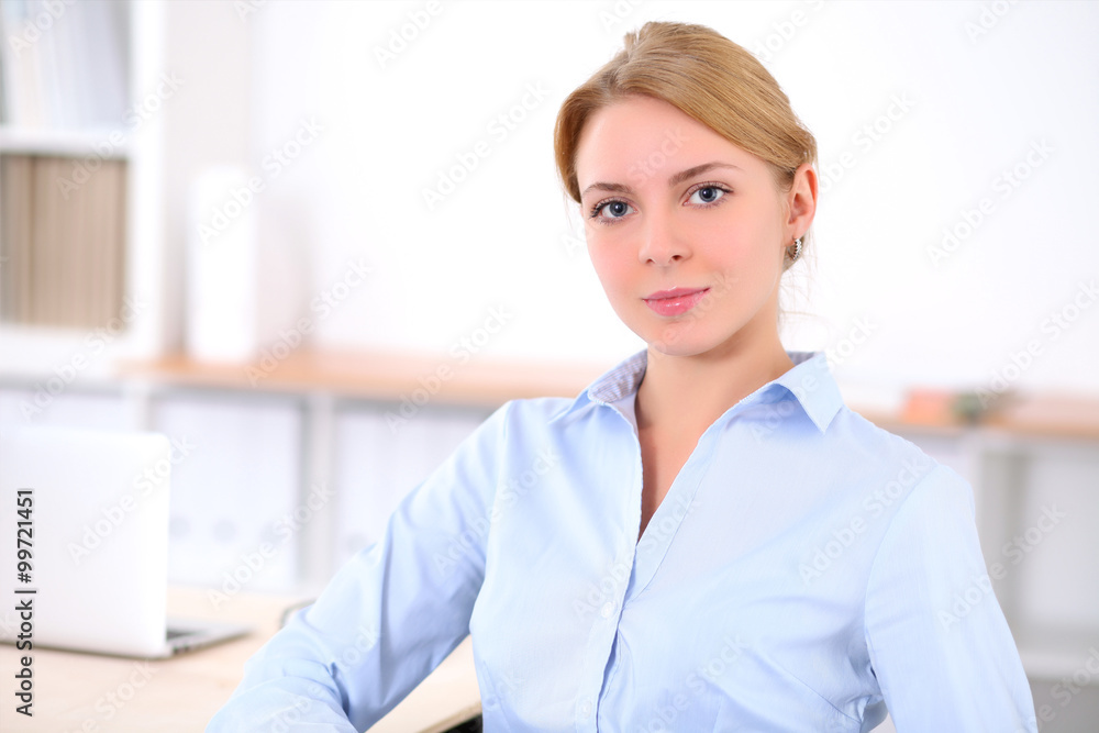 Young blonde business woman with laptop in the office. Business concept. Young blonde business woman with laptop in the office. Business concept.