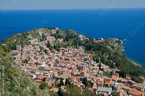 The ancient city of Taormina with the ruins of the Greek Roman theater from view , Sicily, Italy