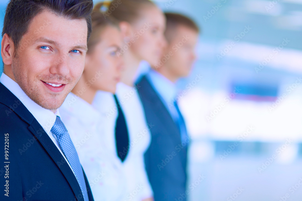 Smiling successful business team standing in office Smiling successful business team standing in office