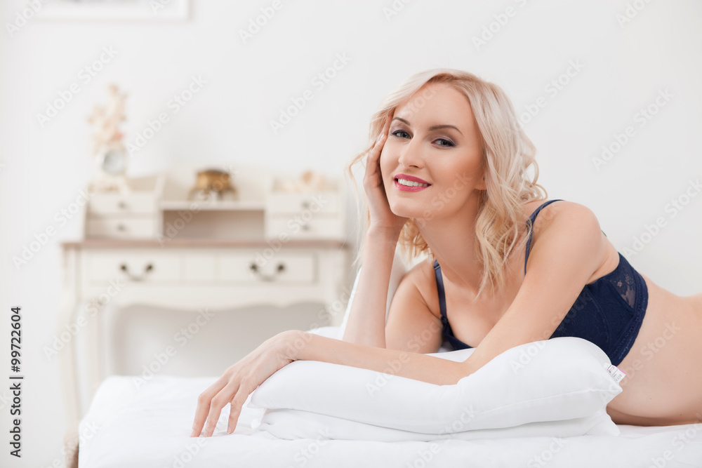 Pretty blond girl is luxuriating at home