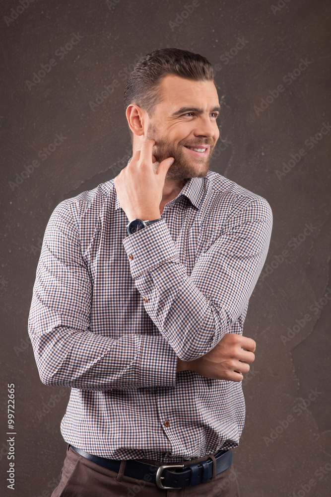 Handsome young bearded man is posing with joy Handsome young bearded man is posing with joy