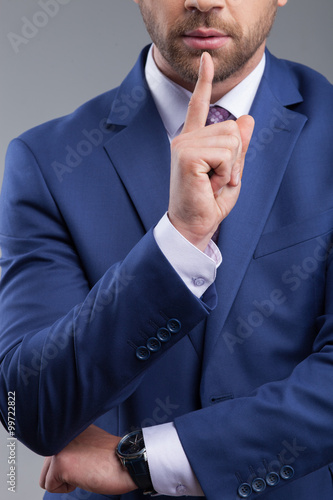 Cheerful young man is asking for silence