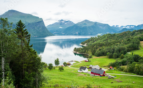 Billede på lærred Small farm with red barn and white house in the Norwegian countr