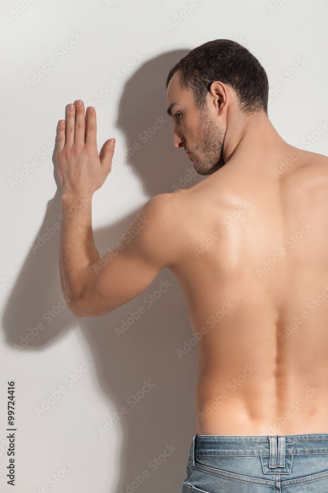 Fototapeta premium Cheerful young guy with seductive figure