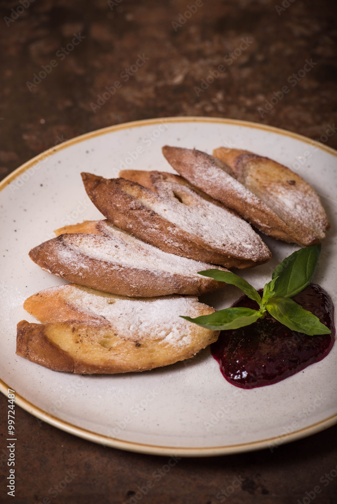 Fototapeta premium French toast with powdered sugar and jam on a plate