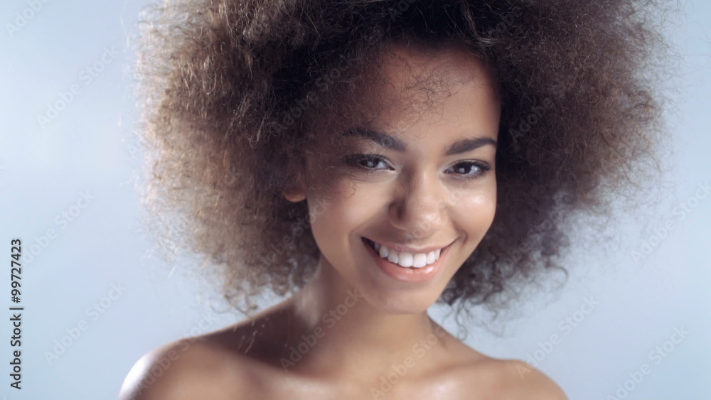 Portrait of a beautiful cheerful young African woman smiling. Portrait of a beautiful cheerful young African woman smiling.