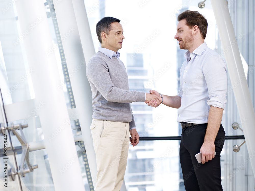 businessmen shaking hands in office businessmen shaking hands in office