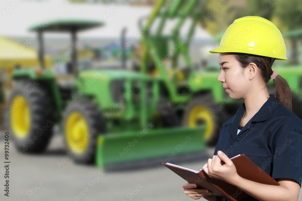 Portrait of smiling young female mechanic inspecting on a car an Portrait of smiling young female mechanic inspecting on a car an