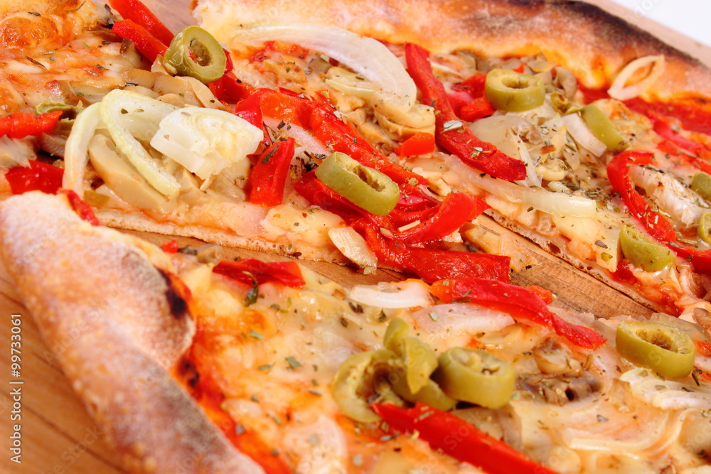 Italian vegetarian pizza on wooden surface Italian vegetarian pizza on wooden surface