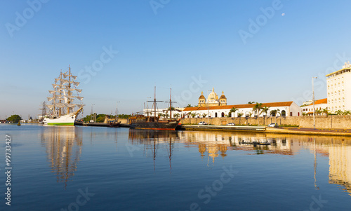 The historic Colombian Tall Ship and old pirate ship moored at the port of Cartagena. Ship and churches reflection in Caribbean waters in Cartagena  Colombia.