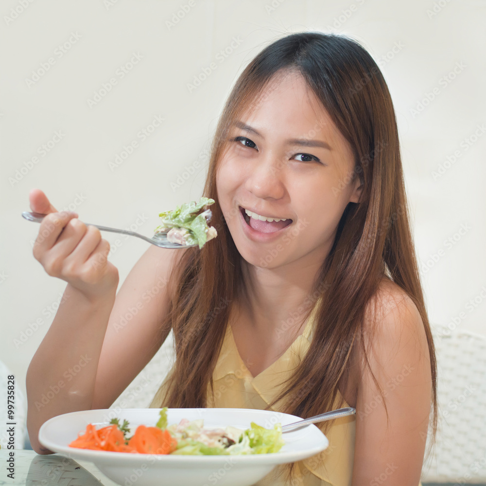 Young happy women eating on table in restaurant Young happy women eating on table in restaurant