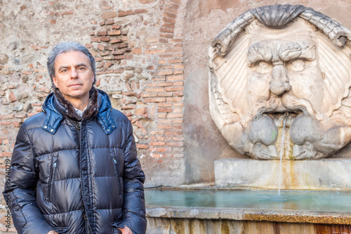 Mature Man near Roman fountain
