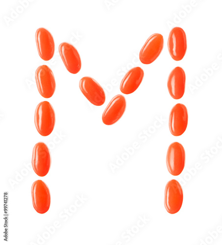 M letter made of red candies isolated on white background
