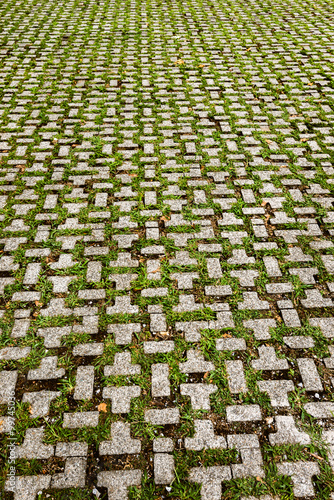 Old pavement of stone tiles in perspective