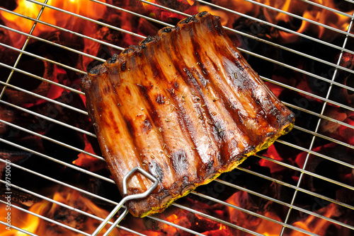 Grilled pork ribs on the flaming  grill