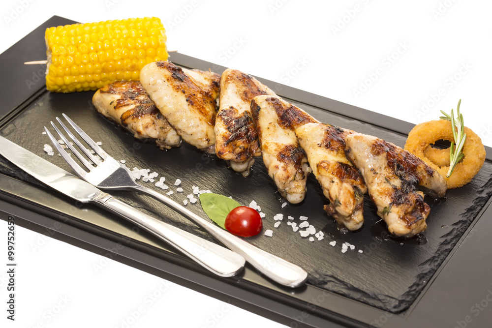 chicken wings are grilled on a wooden platter chicken wings are grilled on a wooden platter