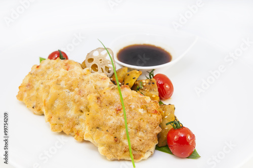 shrimp patties of meat with a salad of eggplant on a white background in restorne