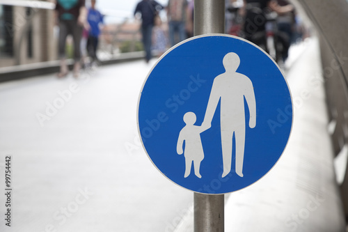 Pedestrian Sign with people in the background and copy space