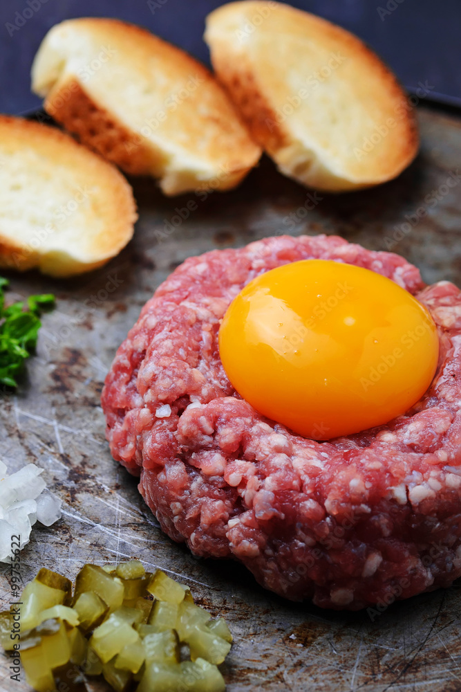Fresh beef tartar with egg, pickled cucumber and onion. Fresh beef tartar with egg, pickled cucumber and onion.