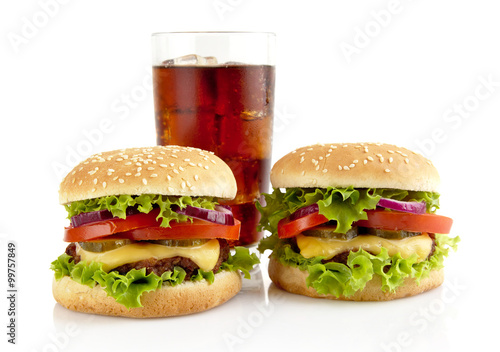 Big two cheeseburgers with glass of cola isolated on white