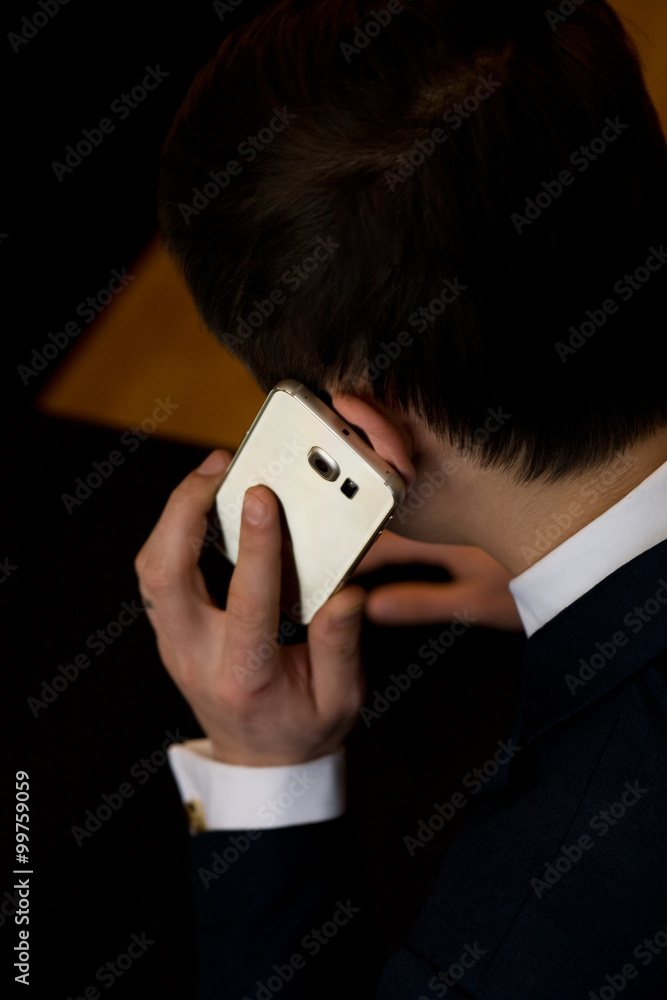 Man in business clothes with cellphone sitting at a table working Man in business clothes with cellphone sitting at a table working