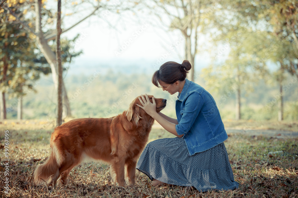 Beautiful woman with a cute golden retriever dog