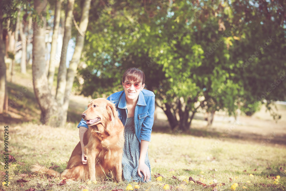 Beautiful woman with a cute golden retriever dog