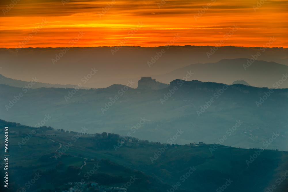 sunset on hilly countryside in winter
