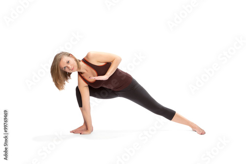 Young woman doing yoga on a white background