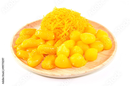 thai sweetmeat dessert made from egg and sugar on wood dish isolate on white background, top view