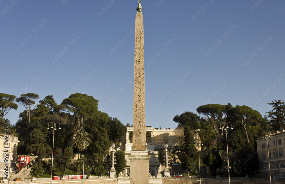 The Egyptian obelisk of Ramesses II in Piazza del Popolo in Rome, Italy, surrounded by trees