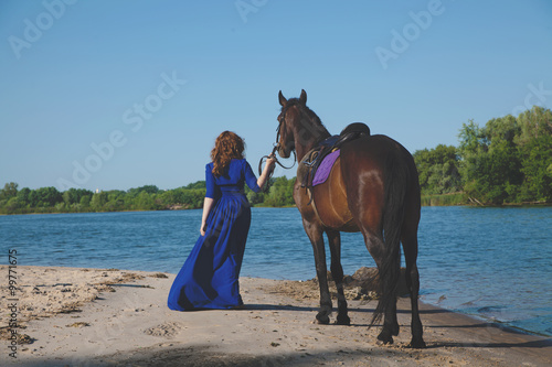 Beautiful young woman with a horse