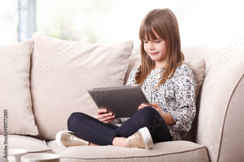 Cute girl with using digital tablet