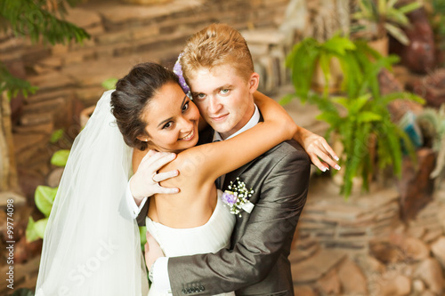 beautiful wedding couple in park. kiss and hug each other