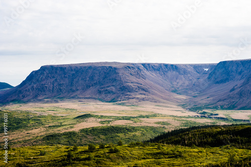 Large mountain plateau and valley under cloudy sky photo