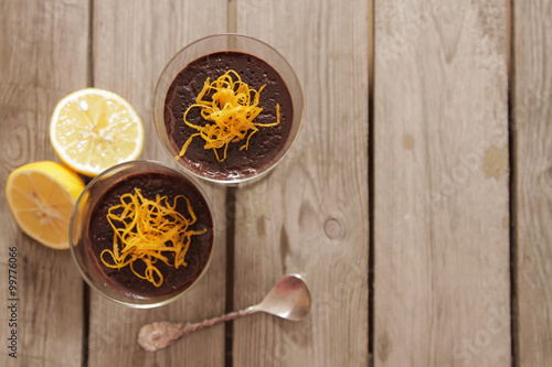 chocolate mousse with orange chips on a dark background