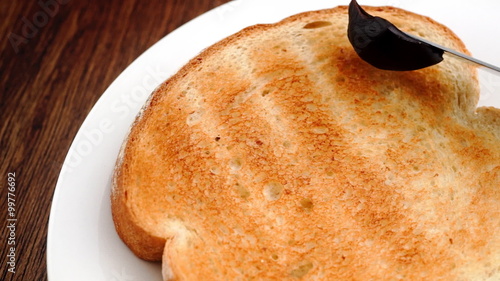 Spreading Australian Vegemite on toast in slow motion