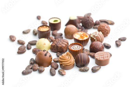 various chocolate pralines and cocoa beans