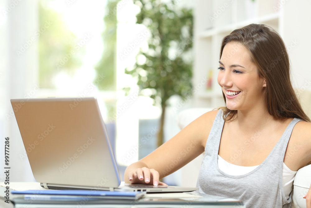 Casual woman using a laptop at home Casual woman using a laptop at home