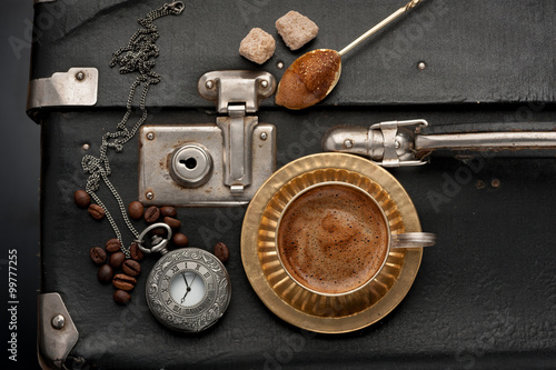 Vintage suitcase, and old clock on a chain and coffee cup