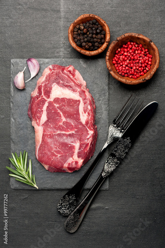 Raw fresh meat Ribeye Steak, seasoning and herbs
