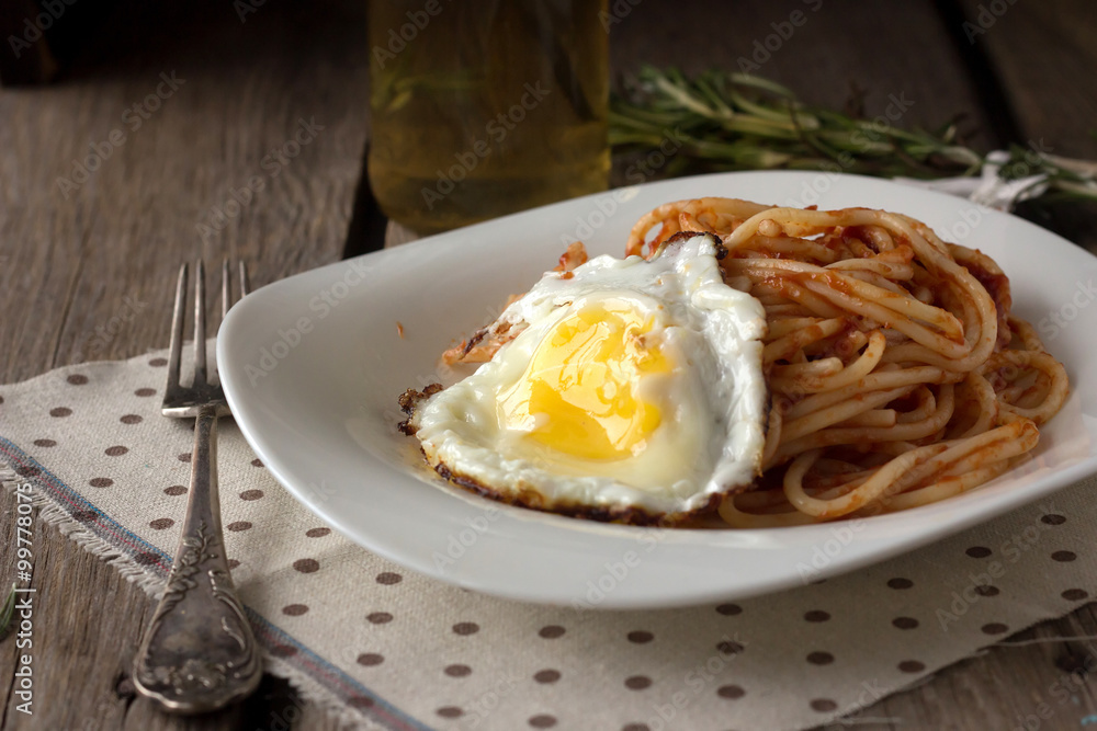Spaghetti with tomato paste and fried egg Spaghetti with tomato paste and fried egg