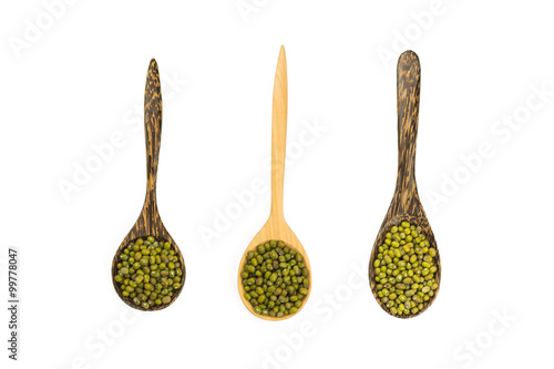 plenty of mung beans on wooden spoon isolated on white top view