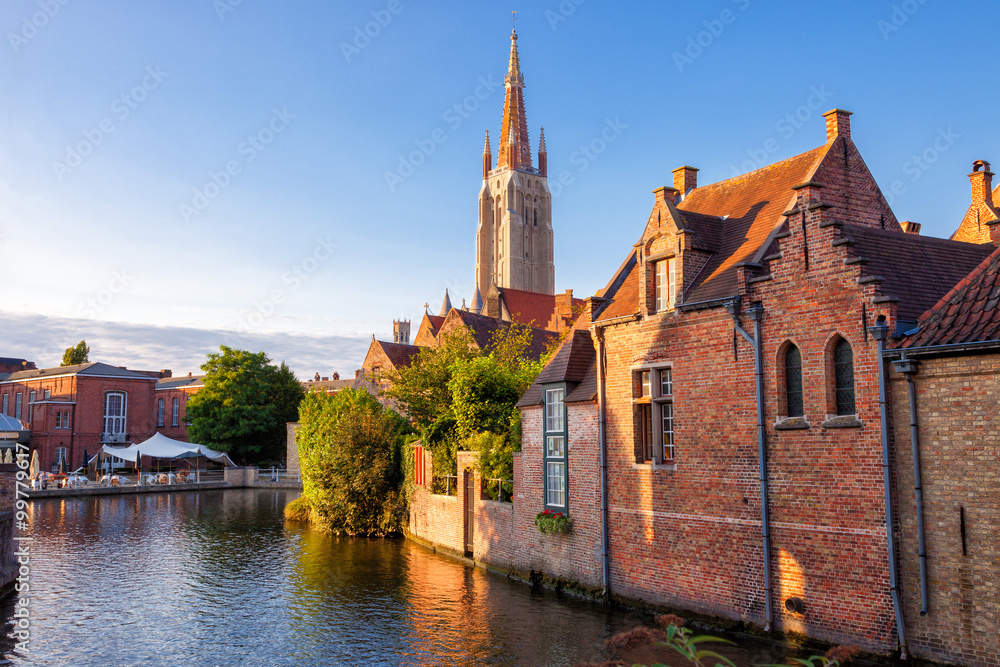 Bruges, Belgium: Canal and medieval houses with the belfry of Onze-Lieve-Vrouwekerk (Church of Our Lady) as background