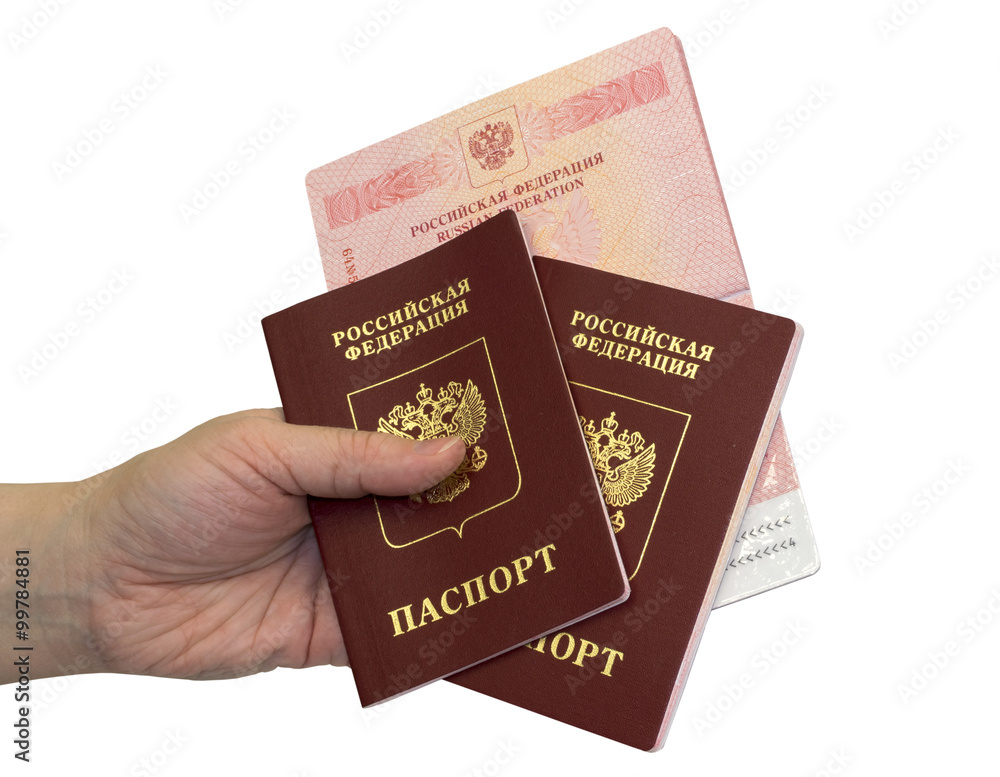 Fototapeta premium Hand with three russian passports on white background