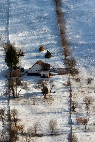 Sunny day of a winter, on wild transylvania hills with Bucegi mountains in background.. 09.01.2016. Sirnea. Romania. Low key, dark background, spot lighting, and rich Old Masters photo