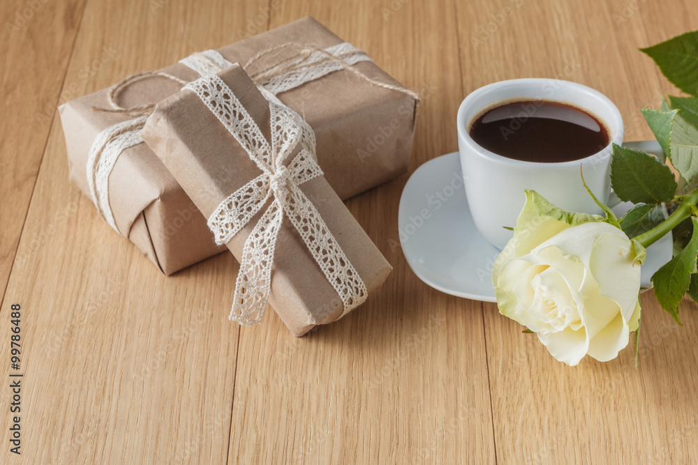 gift box and white rose on wooden background gift box and white rose on wooden background