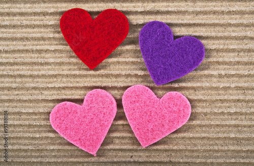 Colored hearts on corrugated cardboard