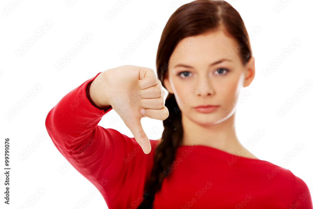 Young unhappy woman with thumb down Young unhappy woman with thumb down
