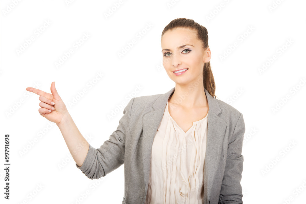 Businesswoman pointing aside.